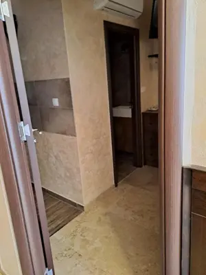 an open door to a bathroom with a walk in shower at Retro studio in Zemun