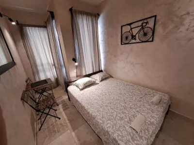 a bedroom with a bed and a picture of a bike on the wall at Retro studio in Zemun