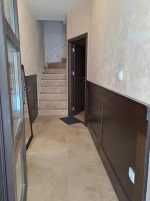 a hallway with stairs and a black door and a staircase at Retro studio in Zemun