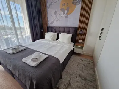 a hotel room with a bed with towels on it at Aqua Royal BW studio in Sajmište