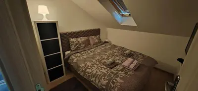 a small bedroom with a bed with a purse on it at Due in Belgrade