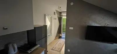 a living room with a flat screen tv on a wall at Due in Belgrade