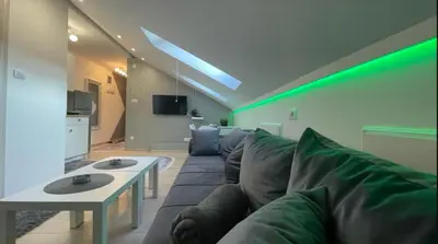a living room with a couch and a table at Due in Belgrade
