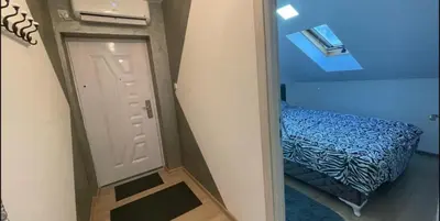 a small room with a door and a small bed at Due in Belgrade