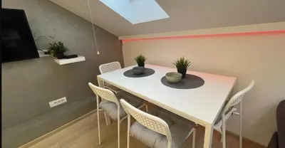 a dining room with a white table and chairs at Due in Belgrade
