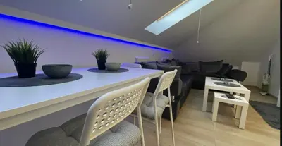 a kitchen and living room with a table and chairs at Due in Belgrade