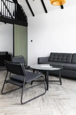 a living room with a table and a couch at Ruža vetrova in Mislođin