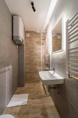 a bathroom with a white sink and a shower at Forty One Suites Belgrade Apartments in Voždovac
