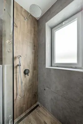 a bathroom with a shower with a window at Forty One Suites Belgrade Apartments in Voždovac