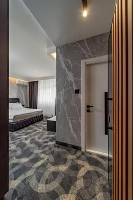 a hotel room with a bed and a sliding door at Forty One Suites Belgrade Apartments in Voždovac