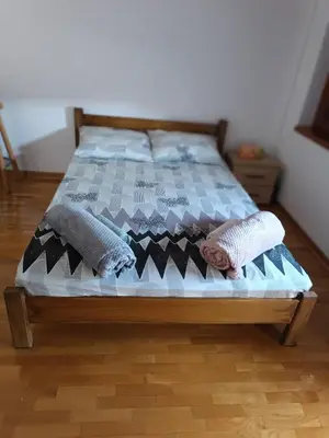 a bed with pillows on it in a bedroom at Kutak-Corner in Vračar (historical)