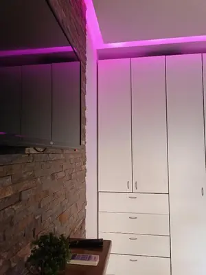 a kitchen with white cabinets and purple lighting at Kutak-Corner in Vračar (historical)