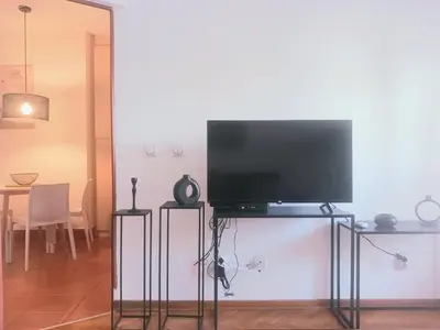 a flat screen tv on a stand in a living room at DukeStepa in Belgrade