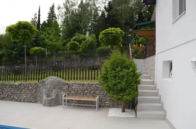 a stairway with a bench and a stone wall at LipaHill SPA in Ripanj