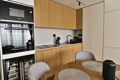 a kitchen with a table and chairs and a stove at Belgrade City Escape - Genex in Belgrade