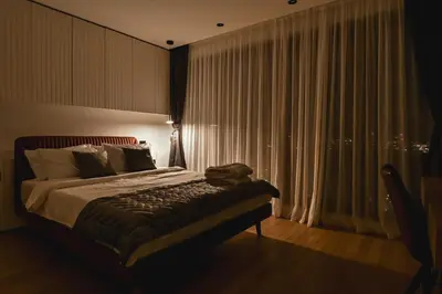 a bedroom with a bed and a window with curtains at Belgrade City Escape - Genex in Belgrade