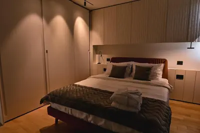 a bedroom with a large bed with white sheets and pillows at Belgrade City Escape - Genex in Belgrade