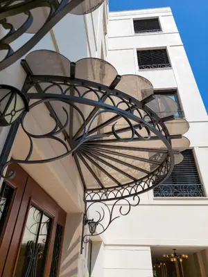 a wrought iron light fixture on the side of a building at Unique Premium Penthouse with Spa and Gym in Dedinje in Belgrade
