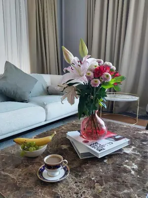 a vase of flowers on a table in a living room at Unique Premium Penthouse with Spa and Gym in Dedinje in Belgrade