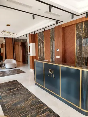 a lobby with a reception desk with the m logo on it at Unique Premium Penthouse with Spa and Gym in Dedinje in Belgrade