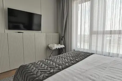 a bedroom with a bed and a large window at Belgrade City Escape - Belgrade Waterfront BW Aqua in Belgrade