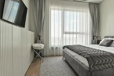 a bedroom with a bed and a large window at Belgrade City Escape - Belgrade Waterfront BW Aqua in Belgrade