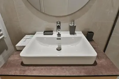 a white sink in a bathroom with a mirror at Belgrade City Escape - Belgrade Waterfront BW Aqua in Belgrade