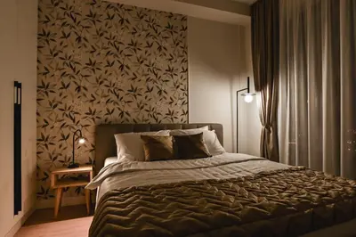 a bedroom with a large bed with a floral wallpaper at Belgrade City Escape - Belgrade Waterfront BW Aqua in Belgrade