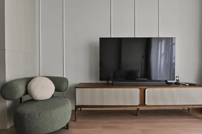 a living room with a chair and a tv at Belgrade City Escape - Belgrade Waterfront BW Aqua in Belgrade