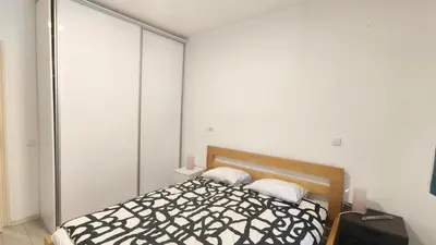 a bedroom with a black and white bed with two pillows at B sweet home S in Belgrade