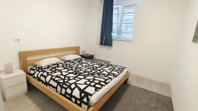 a bedroom with a bed with a black and white comforter at B sweet home S in Belgrade