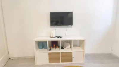 a white cabinet with a tv on top of it at B sweet home S in Belgrade