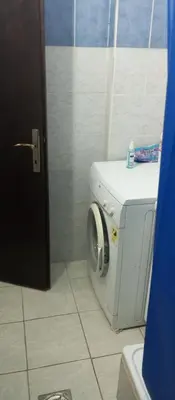 a bathroom with a washing machine in a bathroom at Airport MD Apartment in Belgrade