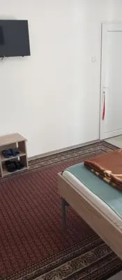 a room with a bed and a table at Airport MD Apartment in Belgrade