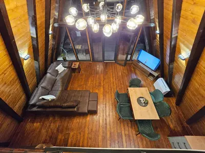 an overhead view of a living room with a couch and a table at Navas River House in Poljane