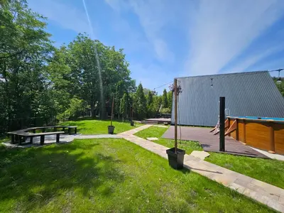 a park with a picnic table and a playground at Navas River House in Poljane