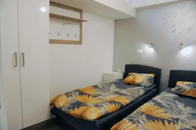 a bedroom with two beds and a closet at 404 Apartment in Belgrade