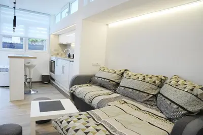a living room with a couch and a kitchen at 404 Apartment in Belgrade