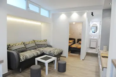 a living room with a couch and a bedroom at 404 Apartment in Belgrade