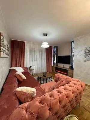 a large brown couch in a living room at Stan na dan, Beograd-Žarkovo in Žarkovo