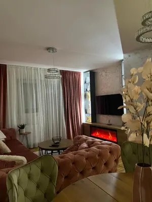 a living room with a couch and a fire place at Stan na dan, Beograd-Žarkovo in Žarkovo