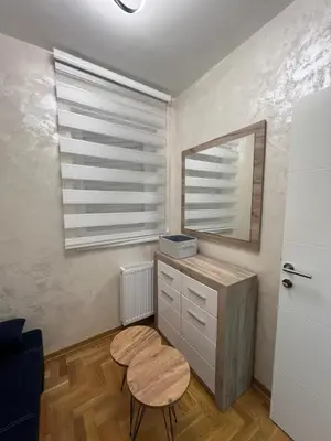 a room with a vanity with a mirror and a stool at Stan na dan, Beograd-Žarkovo in Žarkovo