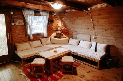 a living room with a couch and a table at Čajnički katun-čardak in Grabovac