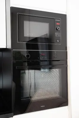 a microwave oven with its door open in a kitchen at Apartment - K District Belgrade in Belgrade