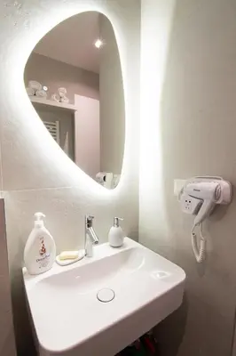 a bathroom with a white sink and a mirror at Apartment - K District Belgrade in Belgrade
