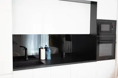 a kitchen counter with a sink and a microwave at Apartment - K District Belgrade in Belgrade