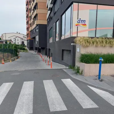 an empty street with orange cones in front of a building at Apartment - K District Belgrade in Belgrade