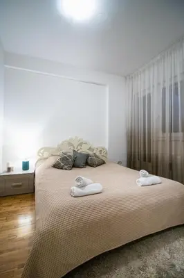 a bedroom with a bed with two towels on it at Angelina city LUX apartment with garage in Belgrade