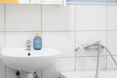 a bathroom sink with a blue bottle on it at Angelina city LUX apartment with garage in Belgrade