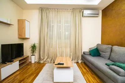 a living room with a couch and a table at Angelina city LUX apartment with garage in Belgrade